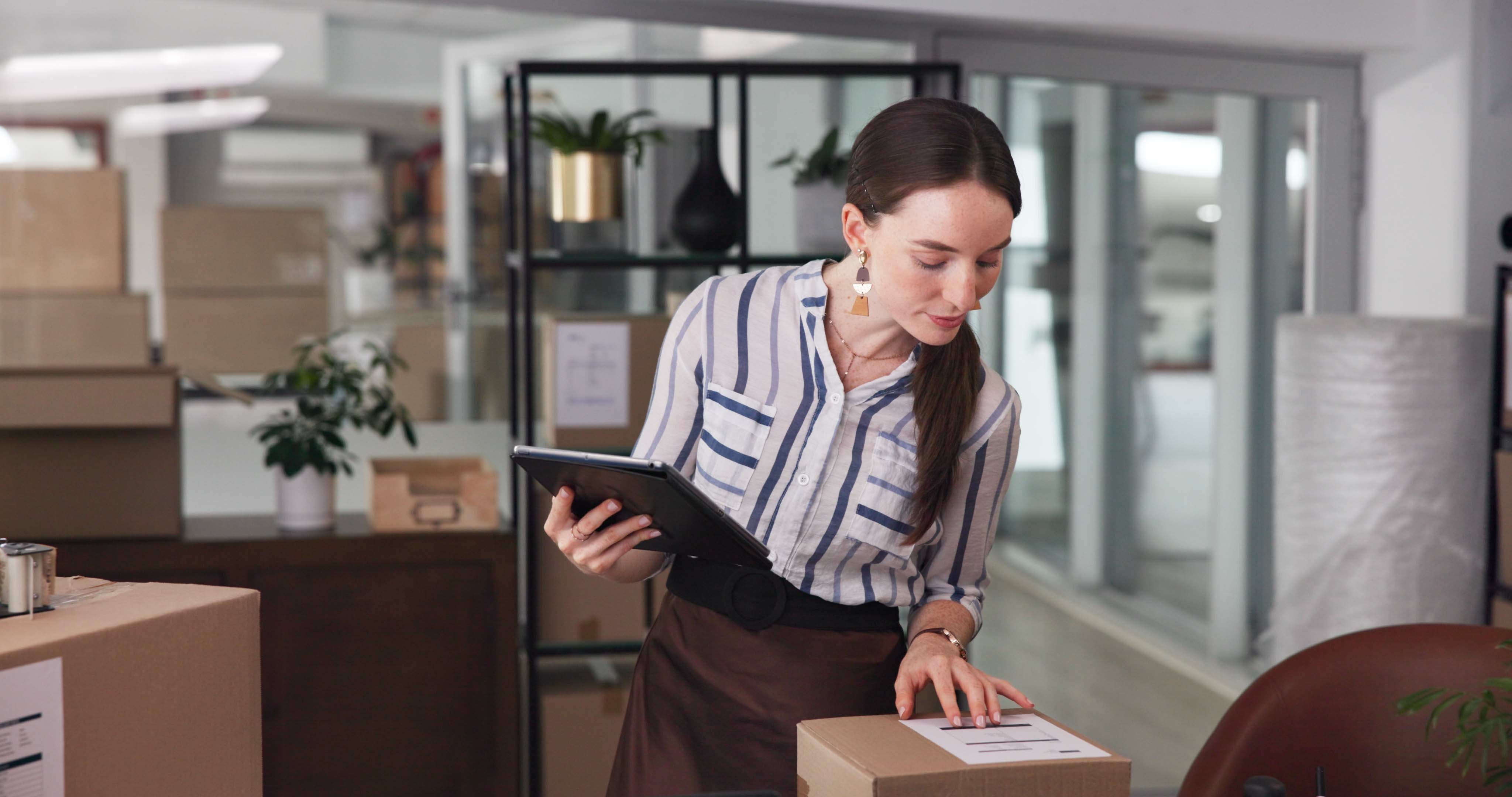 Woman on phone with packages at desk